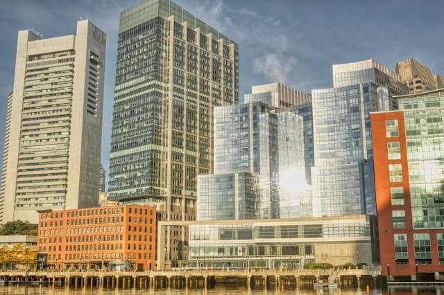 Downtown city skyline with modern skyscrapers reflecting sunlight.