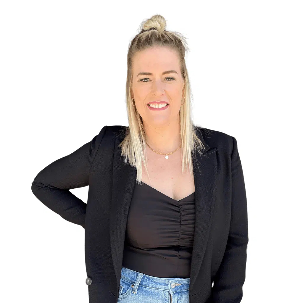 Person smiling wearing black blazer and jeans