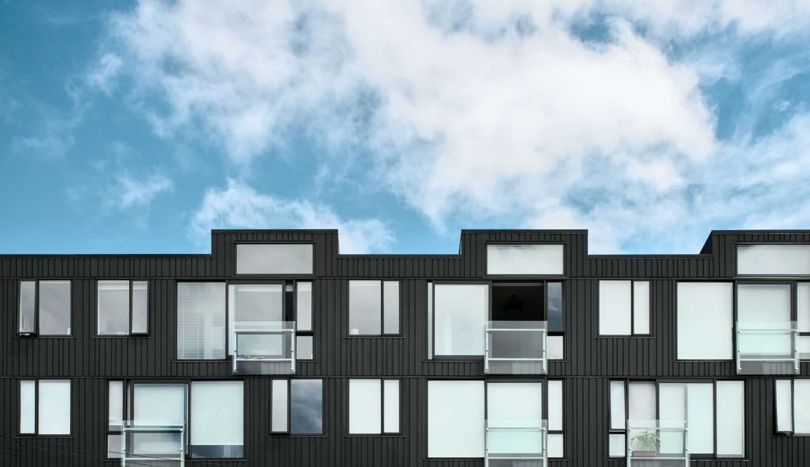 Modern apartment building under blue sky.