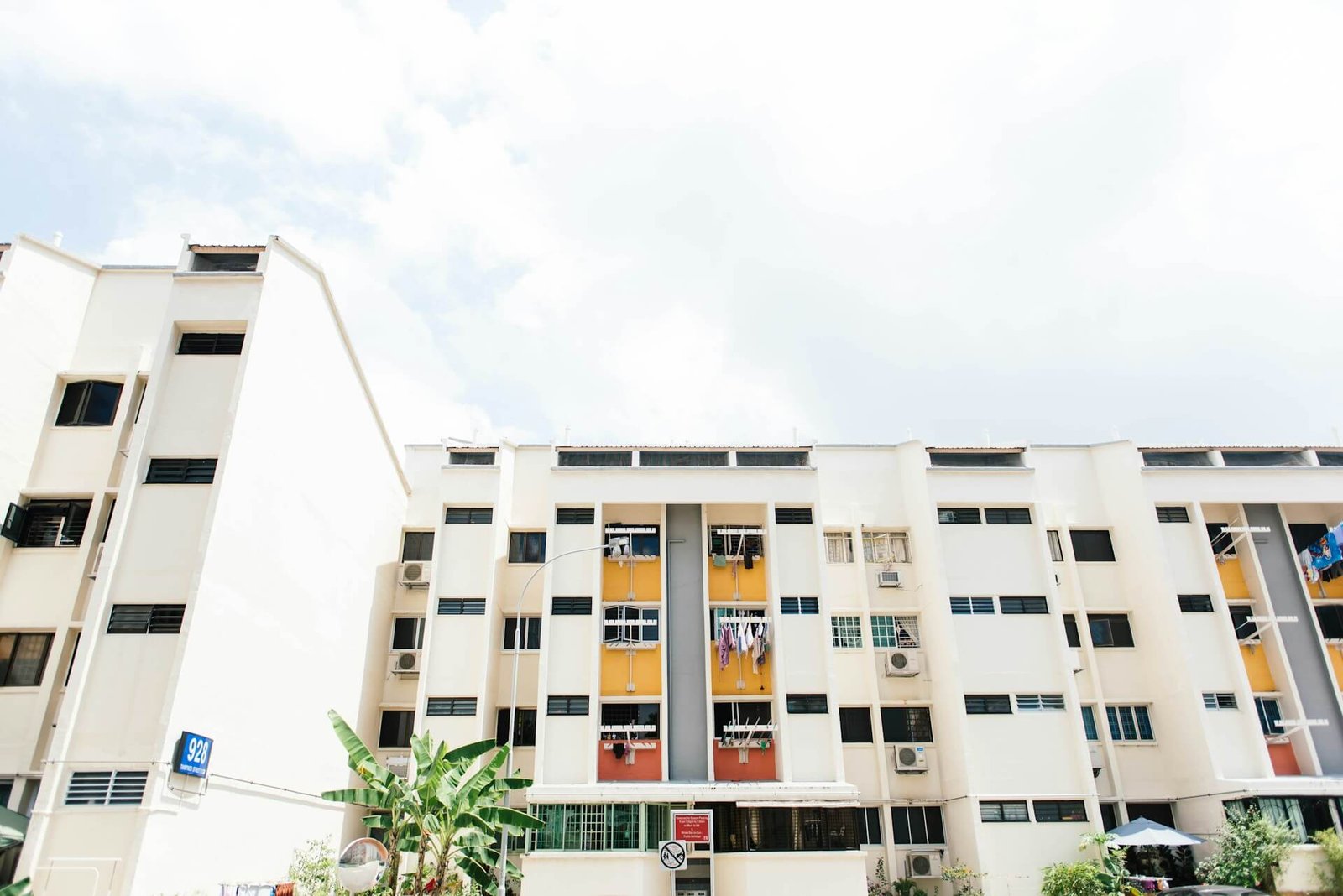 Modern apartment building with yellow balconies.