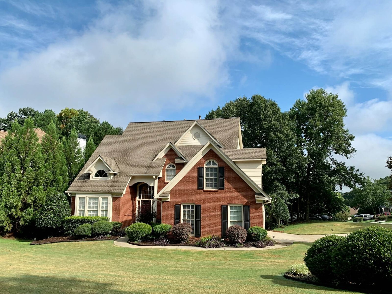 Beautiful suburban house with green lawn and trees.